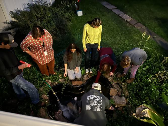 Students help resident with fish pond | | wvnews.com