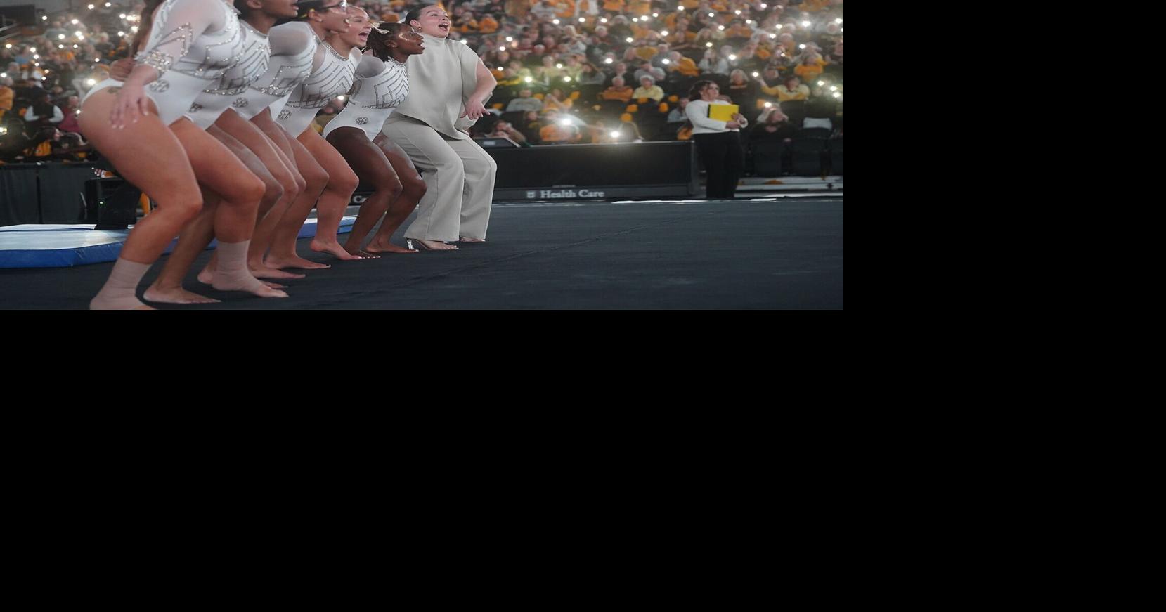 Mizzou gymnasts and one of the coaches link up for the traditional playing