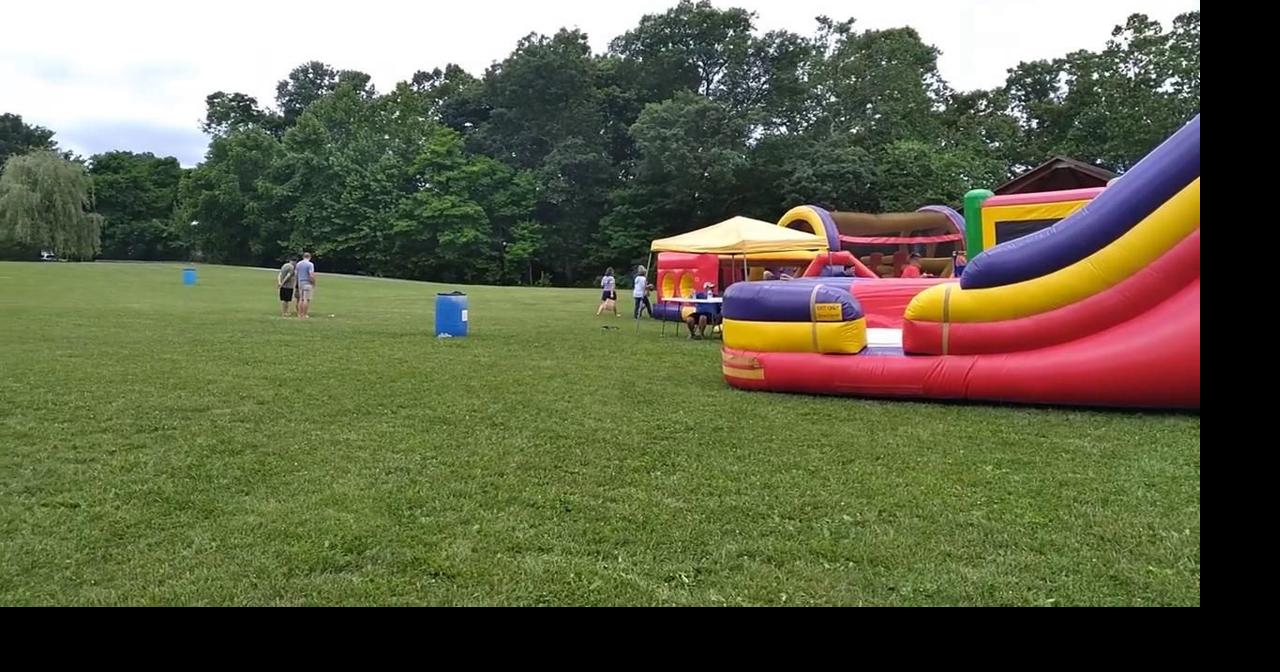 Homemade crafters display their wares among the inflatables in