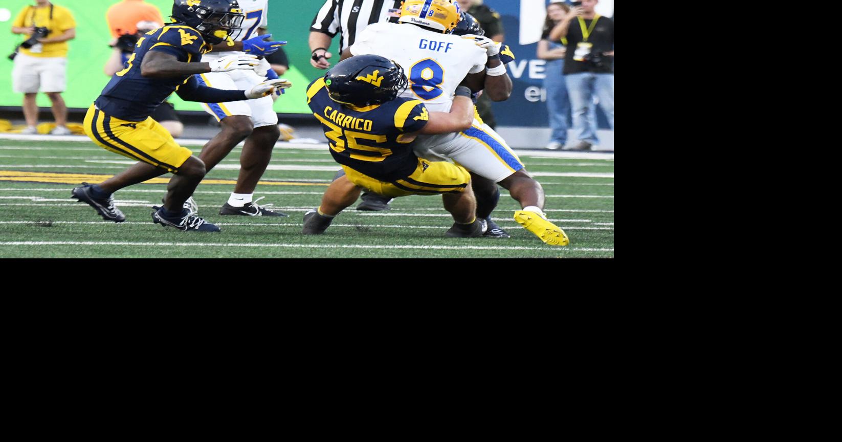 WVU football 0913 Reid Carrico wrestles down front West Virginia