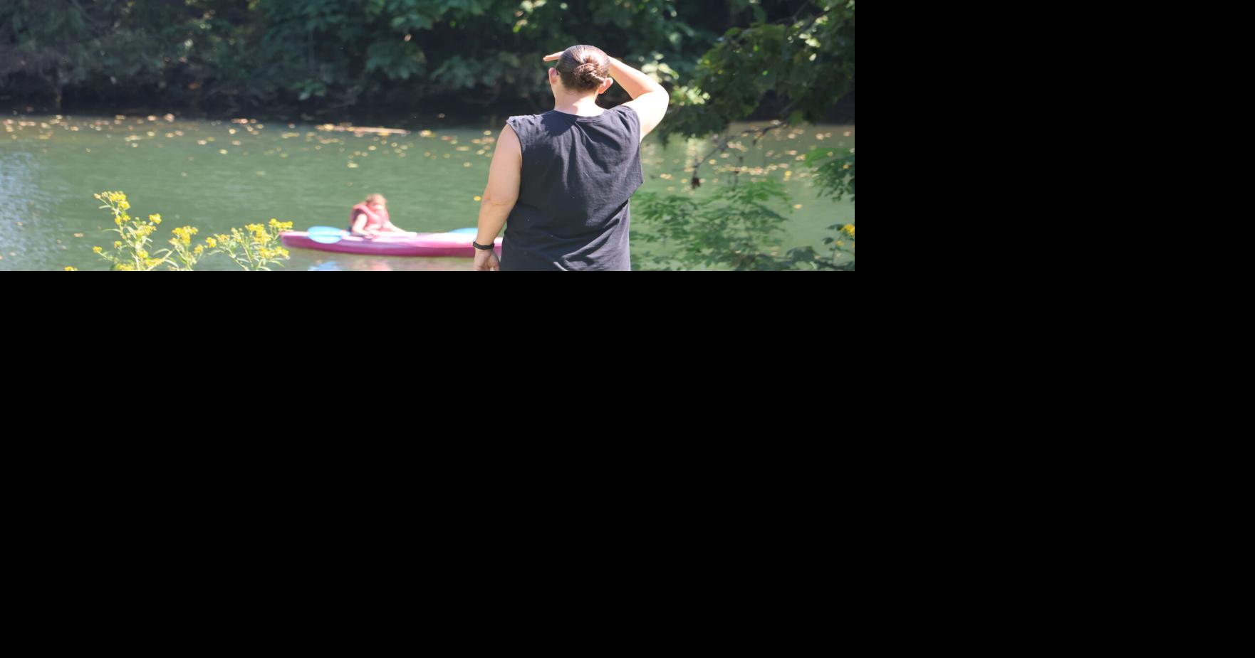 Mother watching daughter paddle