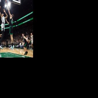 San Antonio's Victor Wembanyama rises for a dunk over Hugo Gonzalez in the Spurs' NBA victory over the Boston Celtics