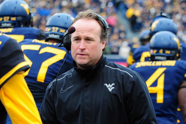 Dana Holgorsen roams the sidelines of the field during WVU's game against TCU.