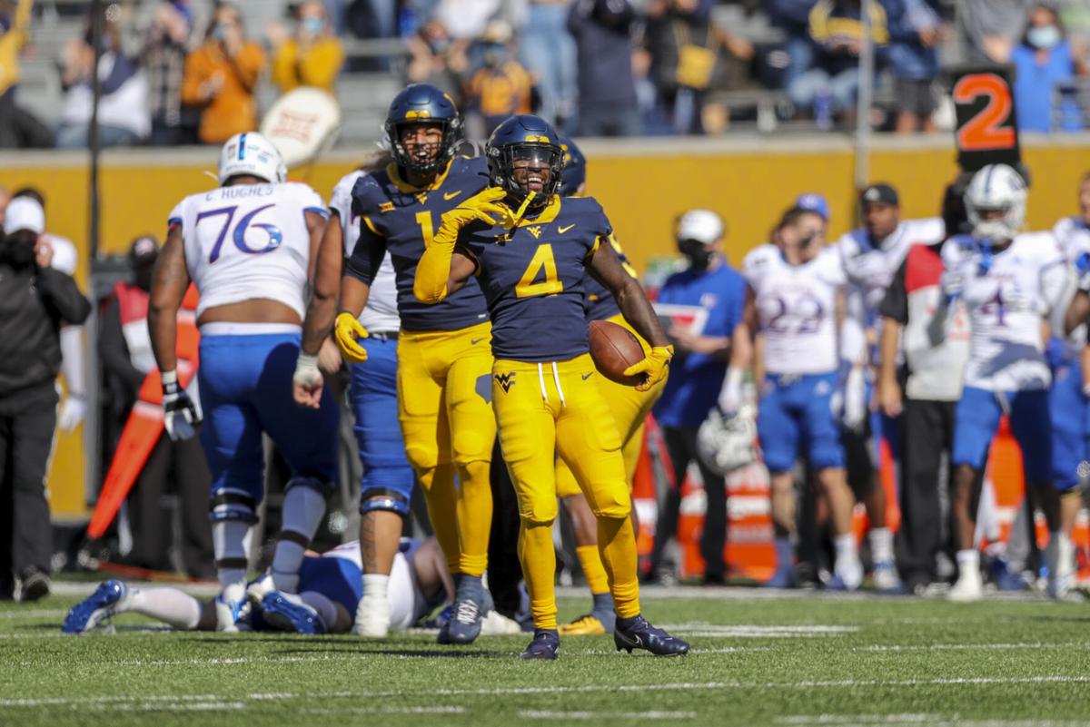 WVU players wearing multiple 'helmets' WVU SPORTS