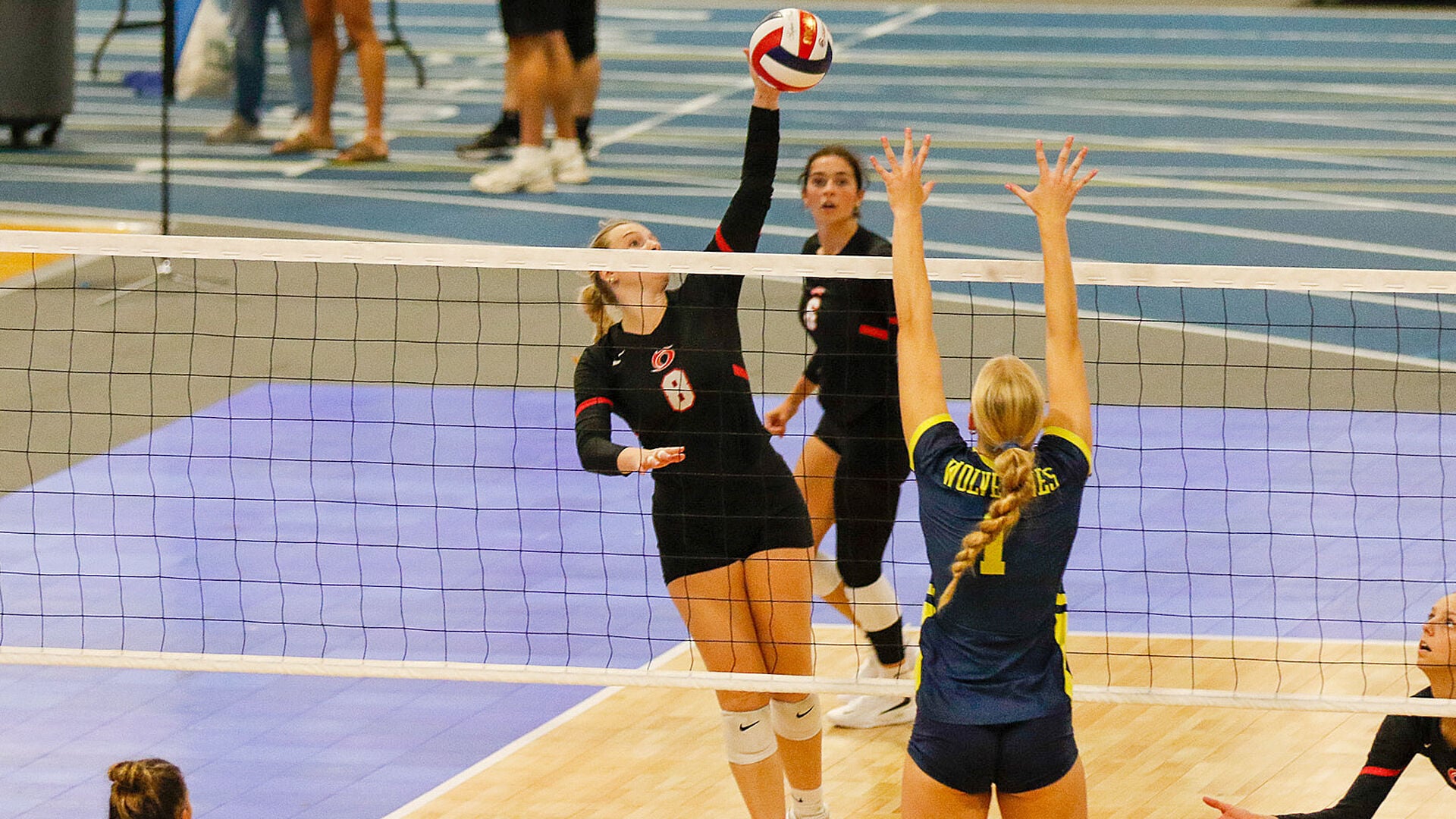 Key player Kelli Stewart executing a powerful kill for Rio Grande against the Wolverines during a successful tournament match