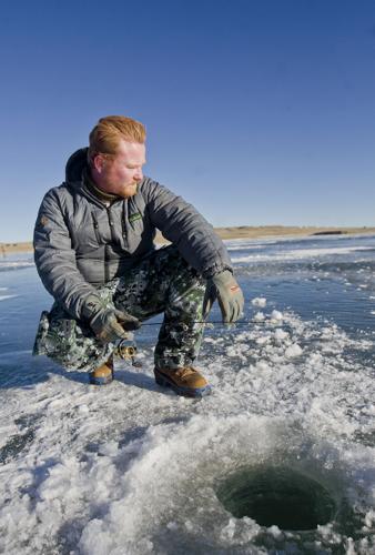 First Time for Everything: Ice fishing hooks local as he trudges across  Lake Hattie on sunny day, News