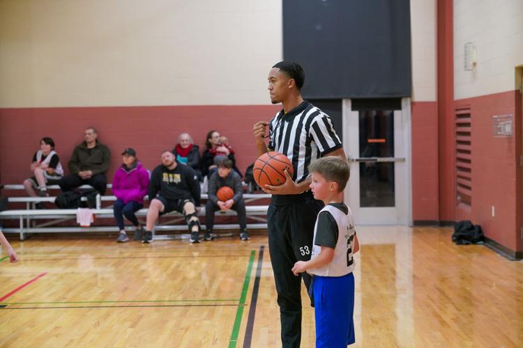 Cowboy hoops' players referee youth basketball games