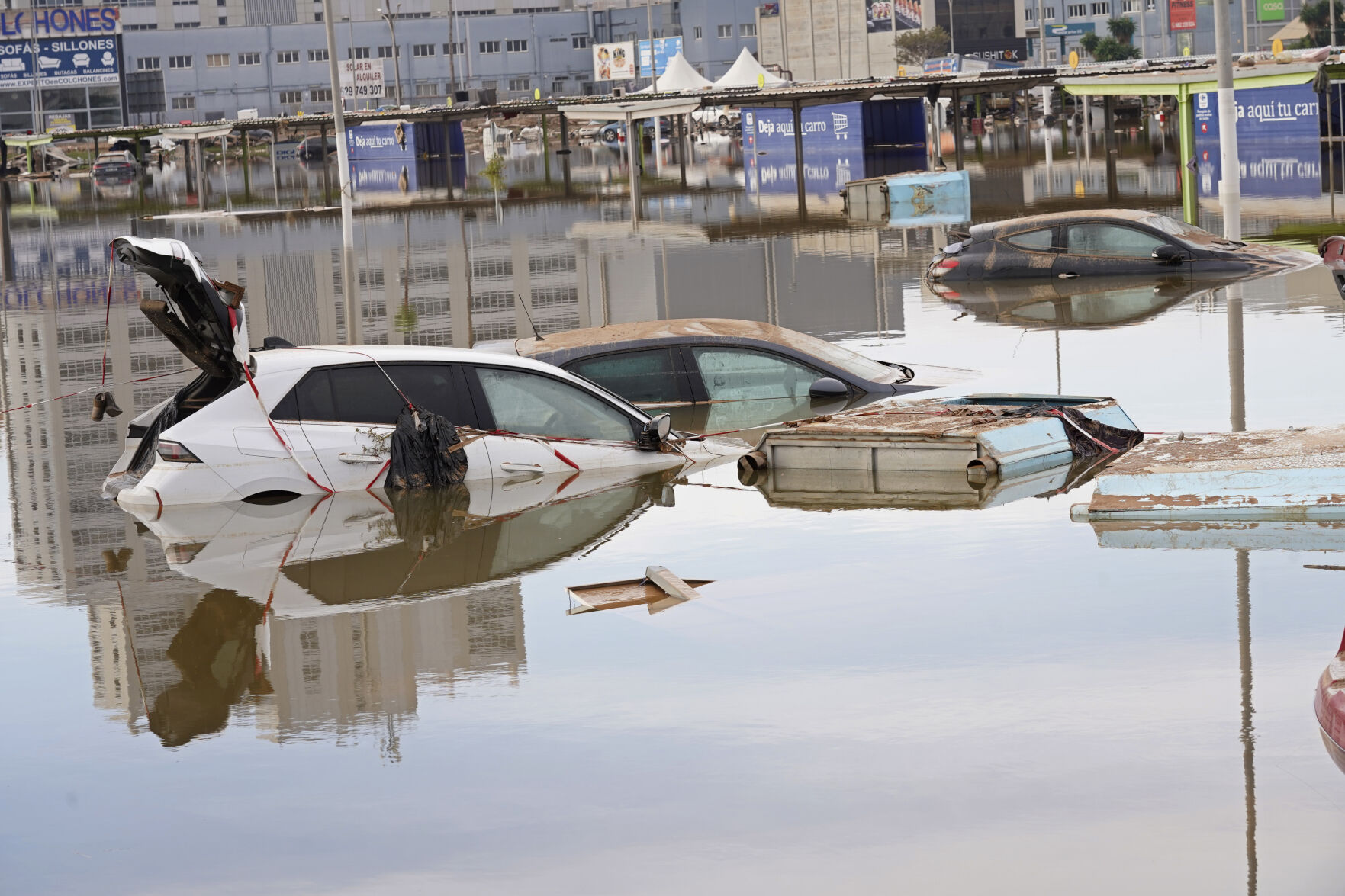 Mud-caked Volunteers Clean Flood Debris In A Spanish Town As ...