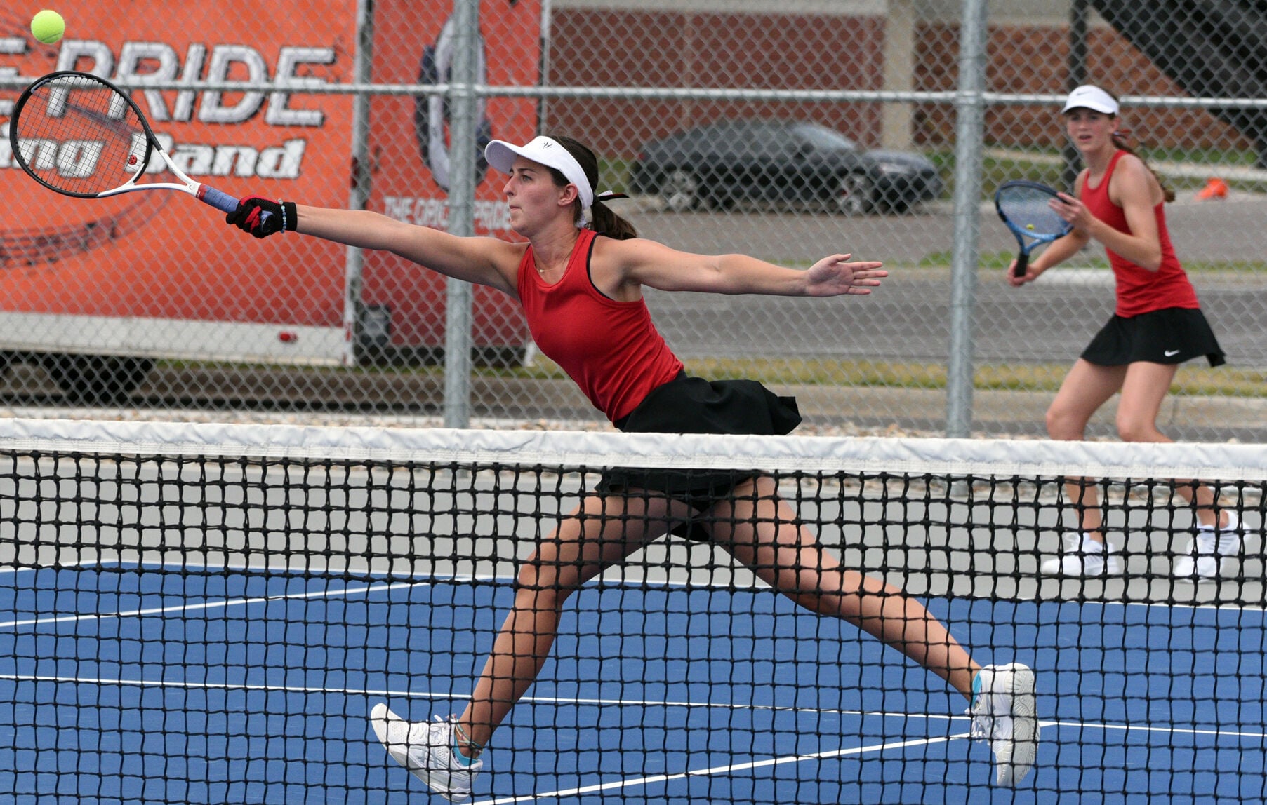 Tennis Tanagers players competing in doubles match at Lennox High School