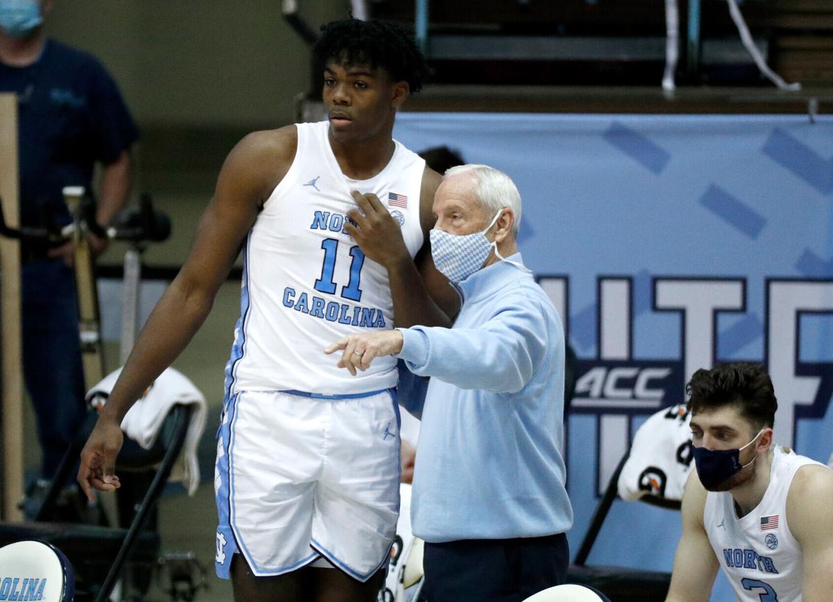 Head coach Roy Williams talks with Day'Ron Sharpe of the North Carolina Tar Heels during the first half against the Wake Forest Demon Deacons on January 20, 2021 at the Dean Smith Center in Chapel Hill, North Carolina.
