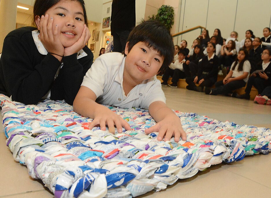 Kids help the needy with milk bag mats