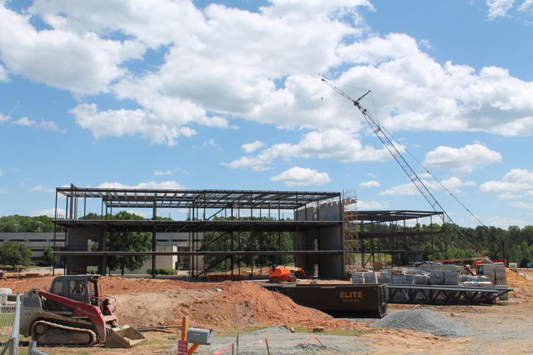 School board receives update on new high school, football coach voices ...