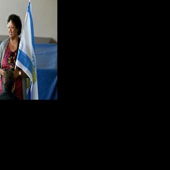 A Fijian woman waves the flag of Jerusalem during the nation's general election in 2022.