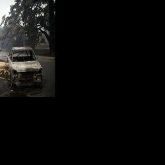 A burnt vehicle is seen on Quinlans street after an overnight bushfire in Quaama in Australia's New South Wales state on January 6, 2020
