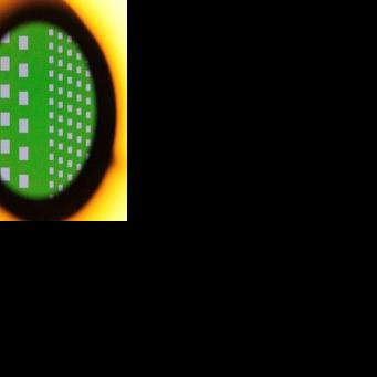 A silicon wafer seen magnified through the lens of a microscope